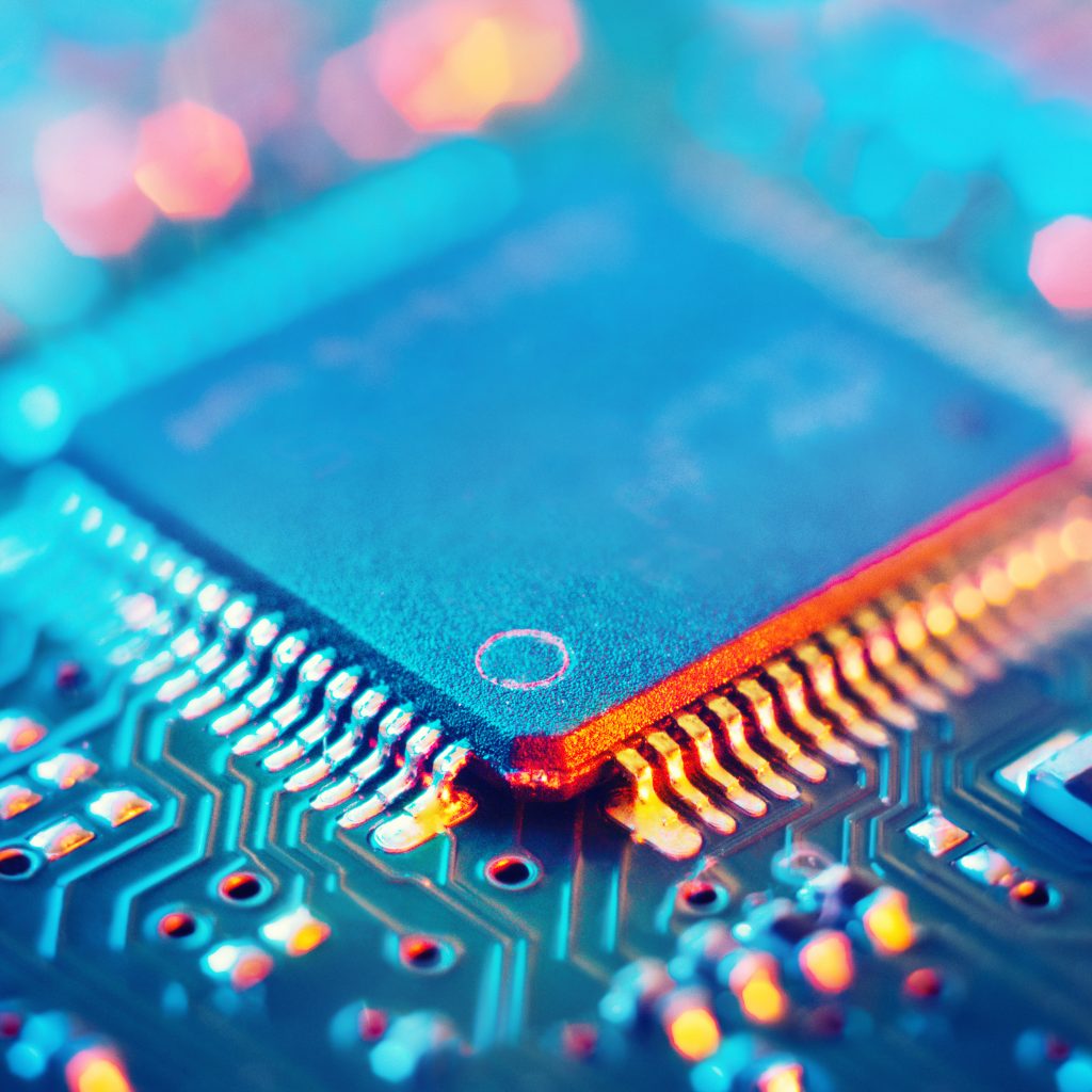 Computer Microchips and Processors on Electronic circuit board. Abstract technology microelectronics concept background. Macro shot, shallow focus.
